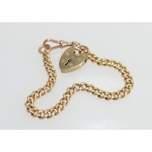 48 - Length of 15ct gold curb link chain united by a 9ct gold padlock clasp with a gold plated spring cli... 