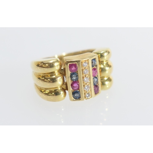 49 - Diamond, ruby and sapphire dress ring, the small round cut stones channel set in three rows, on an 1... 