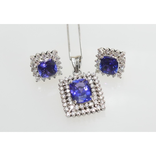 51 - Suite of tanzanite and diamond jewellery comprising pendant necklace, the pendant centred with a cus... 