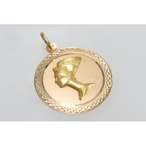 64 - Egyptian 18ct gold souvenir circular pendant featuring Nefertiti, 33mm diameter, weight approx. 10.1... 