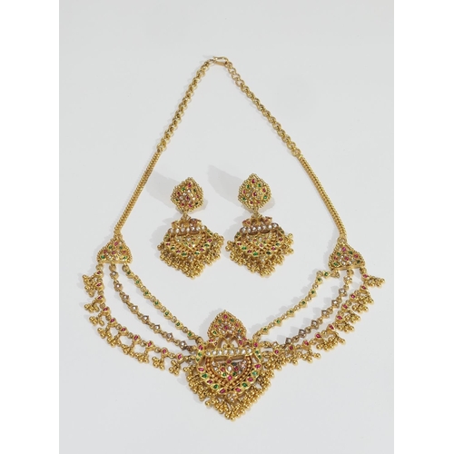 68 - Gold and multi-gem set suite of wedding jewellery, probably Indian, comprising pendant necklace of t... 