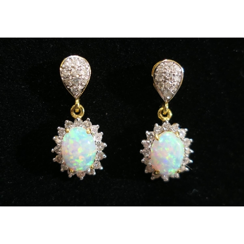 73 - Pair of cabochon opal and diamond pendant earrings in unmarked yellow metal, 21mm drop, gross weight... 