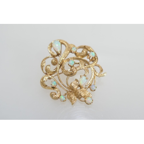 75 - Opal open foliate brooch in 14ct gold, set with nine cabochon opals, the largest of pear shape appro... 