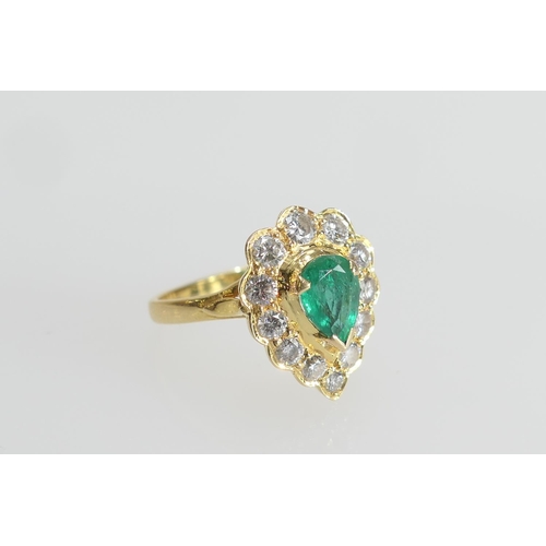 8 - Emerald and diamond cluster ring in 18ct yellow gold, central pear cut emerald of approx. 1ct, surro... 