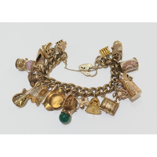 81 - 9ct gold charm bracelet comprising one 18ct gold charm, eighteen 9ct gold charms, and two unmarked c... 