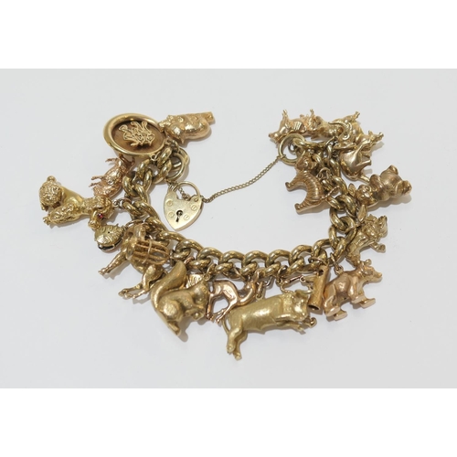 83 - 9ct gold charm bracelet comprising one 15ct gold charm, fifteen 9ct gold charms and four unmarked ch... 