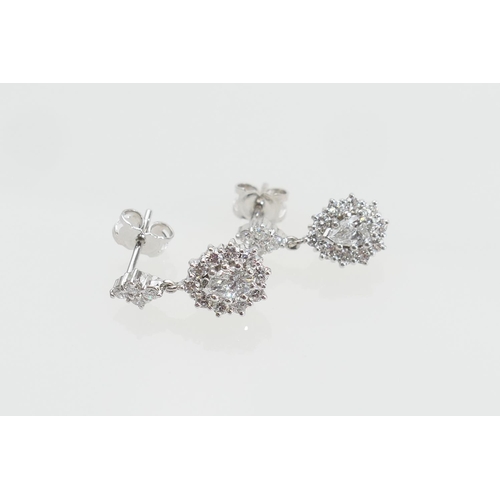 121 - Pair of diamond cluster pendant earrings, each centred with a pear cut diamond of approx. 0.25ct, es... 