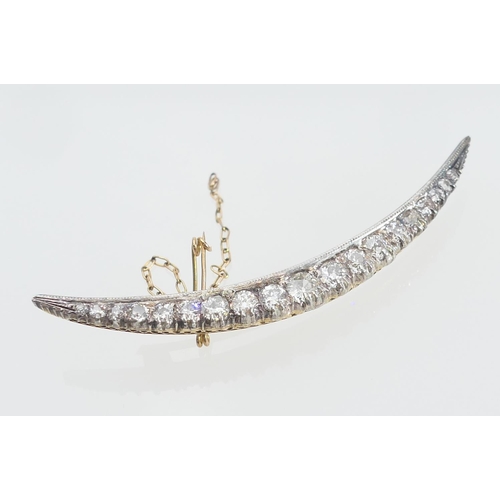 123 - Diamond crescent brooch, set with nineteen old round cut diamonds, the largest centre stone of appro... 