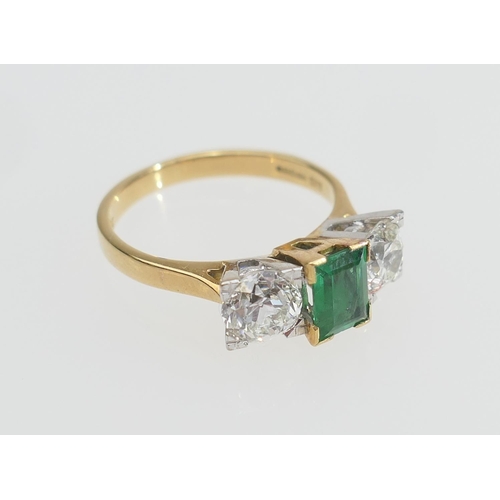 127 - Emerald and diamond three stone ring, the central emerald of approx. 0.75ct flanked by two old round... 