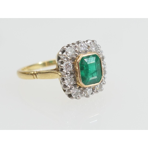 130 - Emerald and diamond cluster ring, the emerald of approx. 1ct, collet set in yellow gold and bordered... 