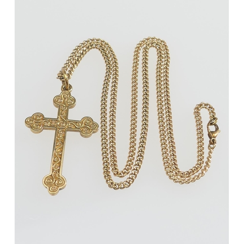 159 - 9ct gold cross form pendant necklace, the pendant with engraved details, 45mm x 25mm, on a curb link... 