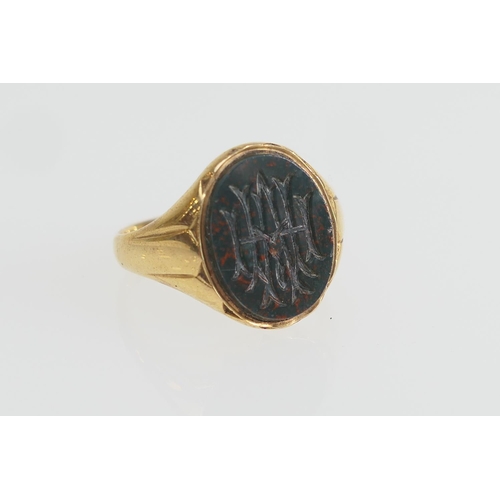 173 - Gent's 18ct gold bloodstone signet ring, the intaglio carved with a monogram, size T, gross weight a... 