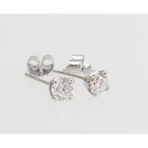 196 - Pair of diamond ear studs, the brilliant cut stones estimated as 0.3ct, colour estimated as K/L and ... 