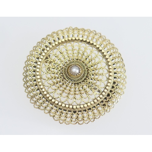 197 - Yellow metal filigree circular brooch, centred with a half pearl within a radiating textured surroun... 