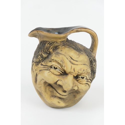 338 - Martin Brothers stoneware double face jug, dated 1903, modelled in bas-relief with a smiling face op... 