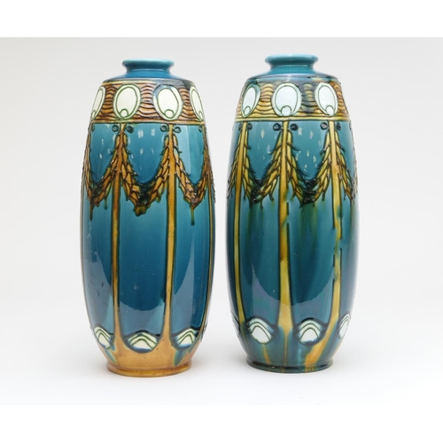 423 - Matched pair of Minton Secessionist vases, circa 1900, each of ovoid form decorated with stylised pe... 