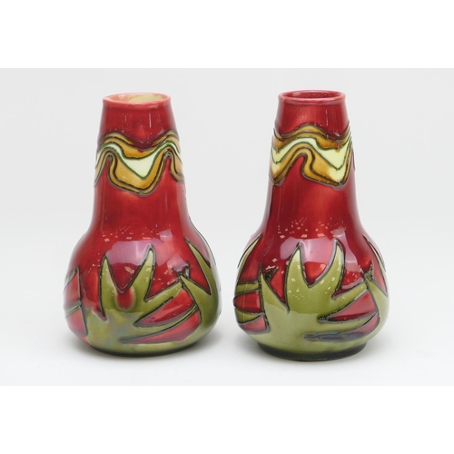 425 - Pair of Minton Secessionist small baluster vases, decorated around the base with spiked green foliag... 