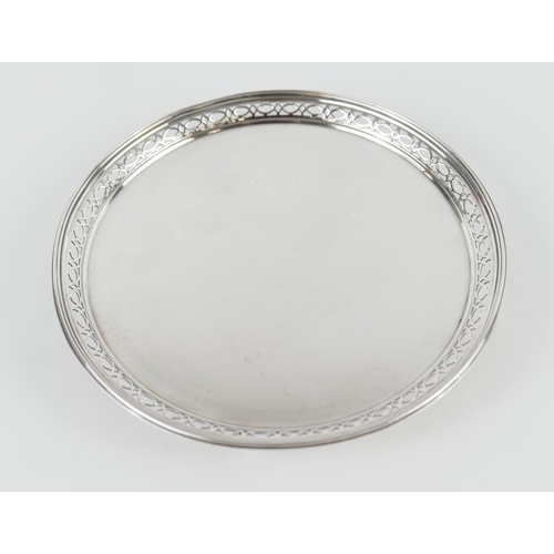 493 - Mappin & Webb silver card tray, London 1908, circular form with a pierced border, raised on four fee... 