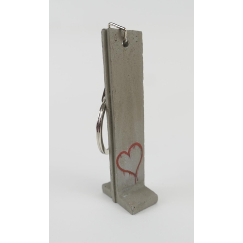 760 - Banksy (British), Walled Off Hotel - Souvenir Wall Section Key Fob (Heart), hand painted resin sculp... 