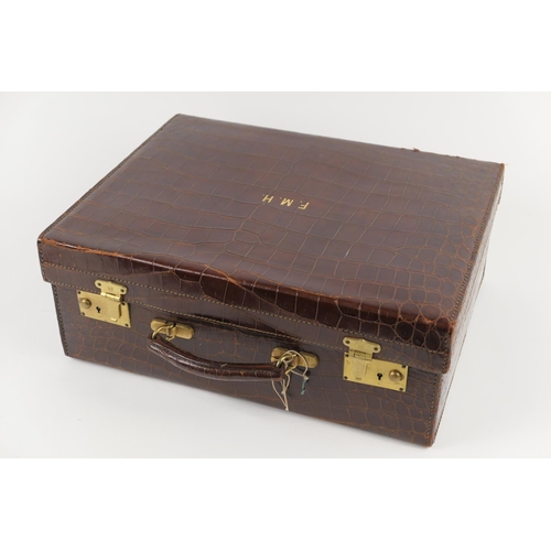 788 - Crocodile skin small suitcase, with brass locks, brown satin lined interior, embossed with gilt init... 