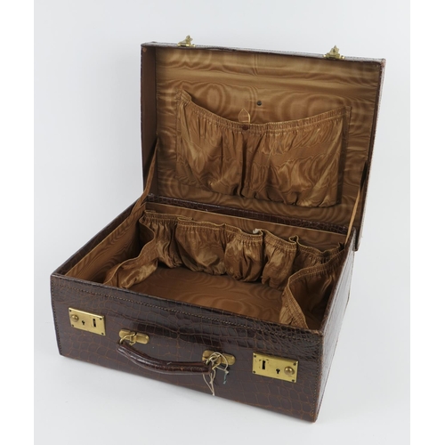 788 - Crocodile skin small suitcase, with brass locks, brown satin lined interior, embossed with gilt init... 