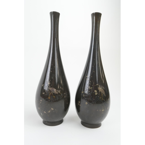 814 - Pair of Japanese bronze and inlaid slender vases, late Meiji (1868-1912), detailed with egrets stand... 