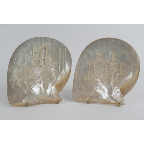 834 - Pair of carved mother of pearl shells 'The Encounter' and 'Fond Farewell', the larger 19cm x 18cm