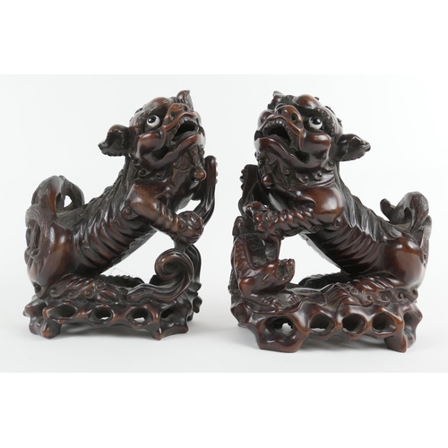 835 - Pair of Chinese carved hardwood Dogs of Fo, late 19th/early 20th Century, with original glass eyes, ... 