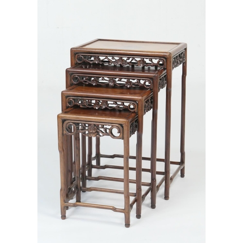 914 - Chinese nest of carved rosewood tables, circa 1900, each having a prunus blossom carved frieze on si... 