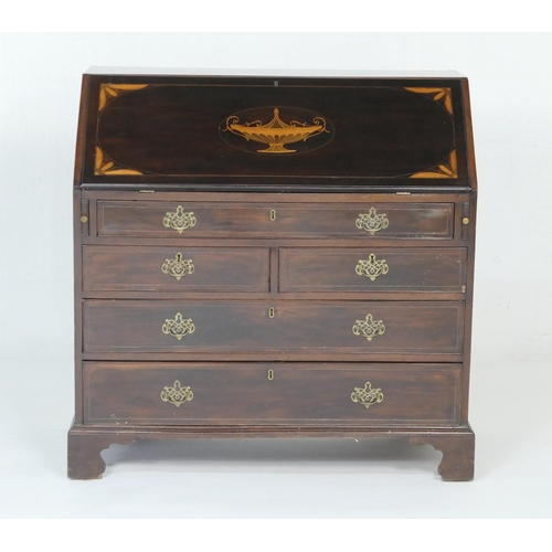 924 - George III mahogany and inlaid bureau, circa 1790, the slope front inlaid with a classical urn in bo... 