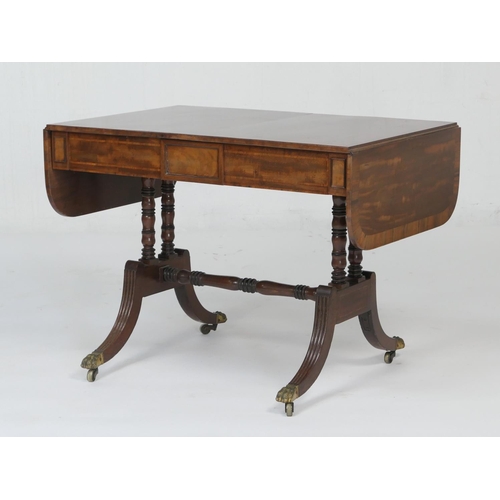 926 - Late Regency mahogany and rosewood banded sofa table, the top with small drop leaves over two frieze... 