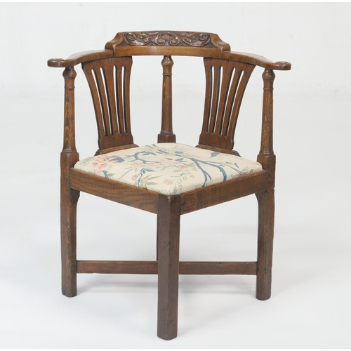 929 - George III oak corner chair, circa 1810, the bowed back with carved toprail, two splats and turned c... 