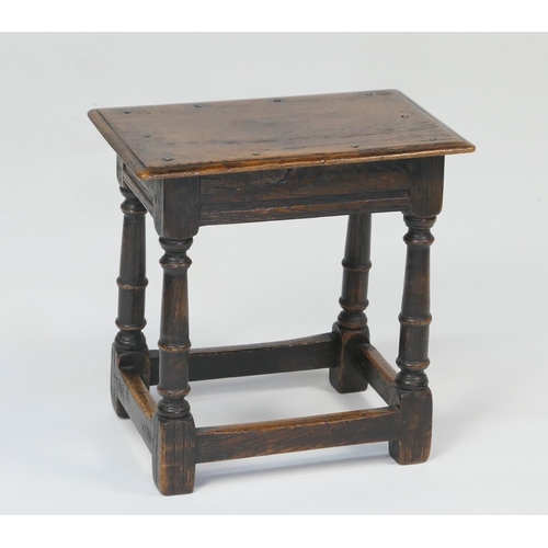 930 - Oak joint stool, the seat with rosehead nails, on a jointed frame with turned legs united by a stret... 