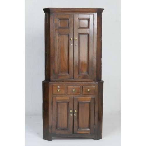 933 - Provincial oak free standing corner cupboard, circa 1800-30, the top with two recessed moulded panel... 