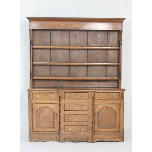 938 - Oak and mahogany breakfront dresser and plate rack, North Wales, early 19th Century, having a three ... 