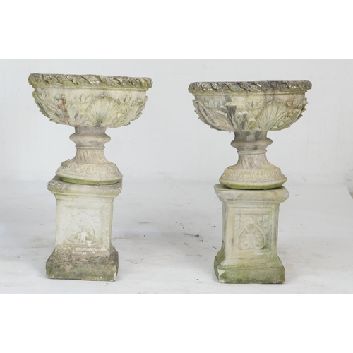 967 - Pair of weathered reconstituted garden pedestal urns, cast with acanthus details, raised on a square... 