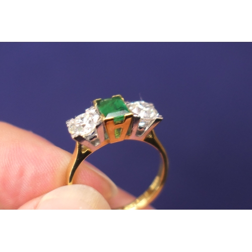 127 - Emerald and diamond three stone ring, the central emerald of approx. 0.75ct flanked by two old round... 