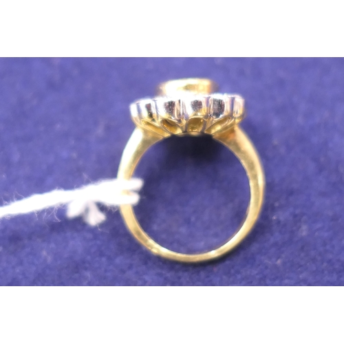 15 - Sapphire and diamond cluster ring, the oval cut sapphire approx. 9mm x 7mm, in a yellow gold collet ... 