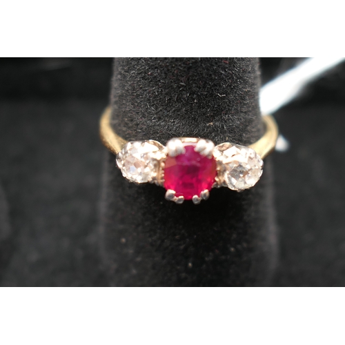 201 - Synthetic ruby and diamond three stone ring, the central cushion cut ruby of approx. 0.5ct, flanked ... 