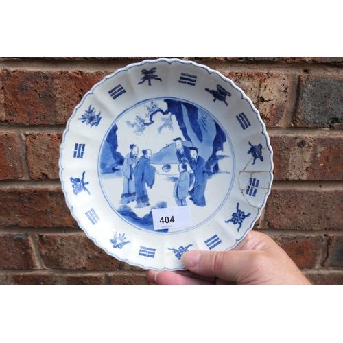 404 - Three Chinese blue and white saucer dishes, Kangxi (1662-1722), each decorated with a central rounde... 