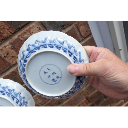 404 - Three Chinese blue and white saucer dishes, Kangxi (1662-1722), each decorated with a central rounde... 