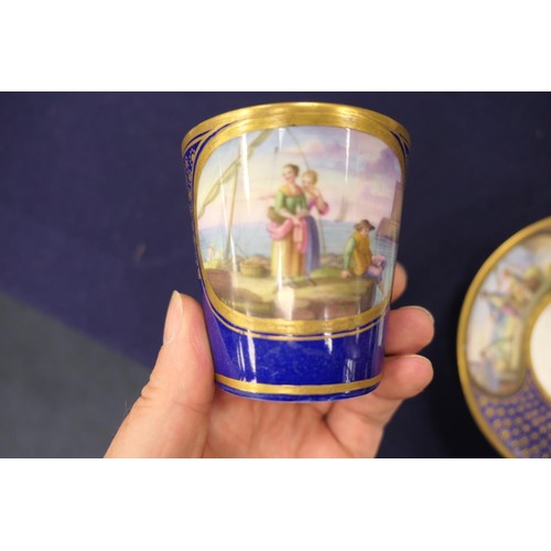 407 - Sevres trembleuse cup and saucer, decorated with panels of figures at a quayside in colours against ... 