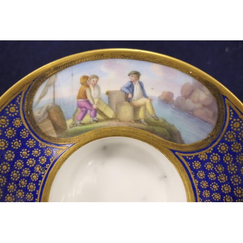 407 - Sevres trembleuse cup and saucer, decorated with panels of figures at a quayside in colours against ... 