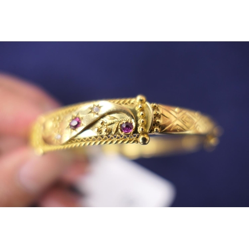 62 - Ruby and diamond hinged bangle in yellow metal,  with Victorian and later elements, cuff size 57mm, ... 