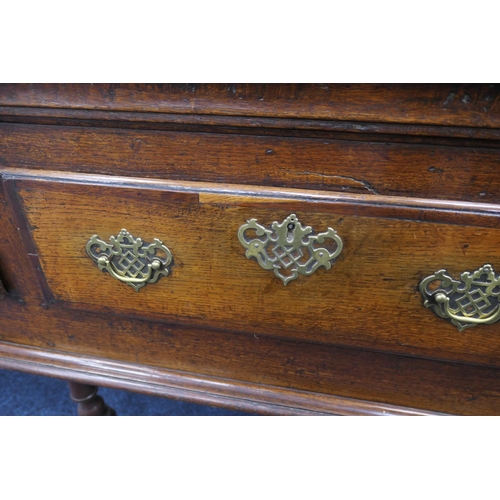 912 - Good Queen Anne oak low dresser, the top with moulded edge over three drawers with later brass fretw... 