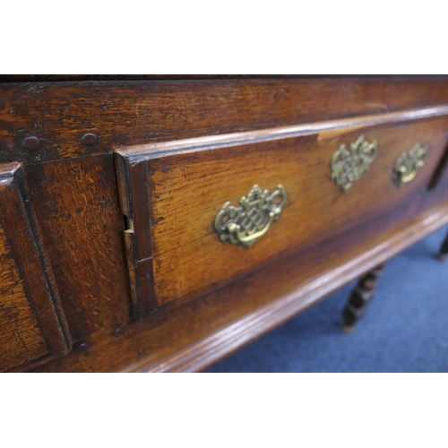 912 - Good Queen Anne oak low dresser, the top with moulded edge over three drawers with later brass fretw... 