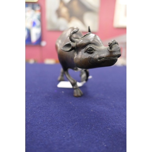 802 - Chinese bronze koro, formed as a man riding a water buffalo, circa 1900, height 19cm