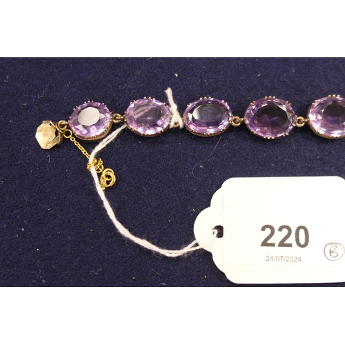 220 - Amethyst riviere necklace, circa 1900, set with 20 oval cut stones, the largest approx. 19mm x 15mm,... 