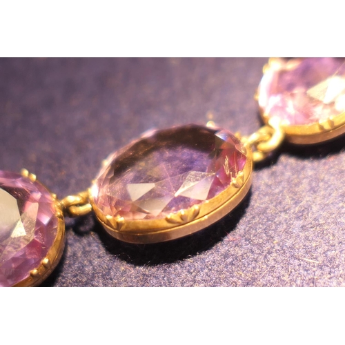 220 - Amethyst riviere necklace, circa 1900, set with 20 oval cut stones, the largest approx. 19mm x 15mm,... 