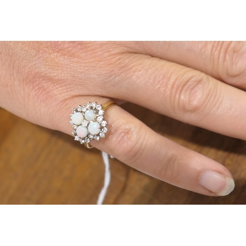 34 - Opal and diamond cluster ring, set with four cabochon round opals, centred and bordered with small b... 